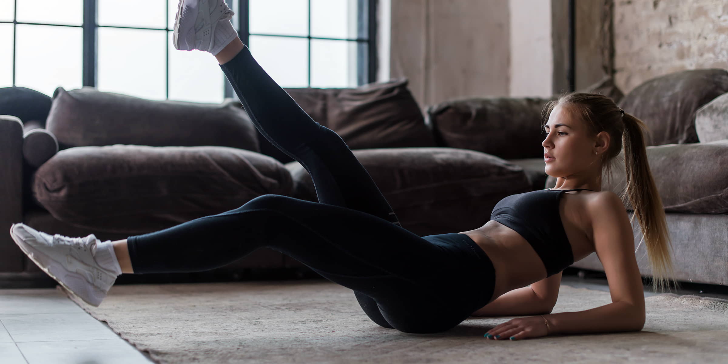 Woman exercising on the living room floor